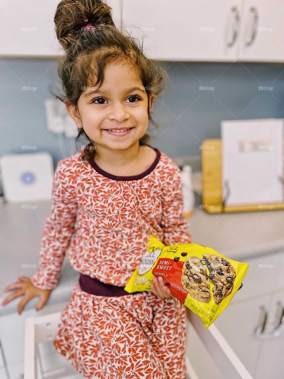 Toddler girl helps mommy make cookies, toddler posing with bag of chocolate chips, making cookies with toddlers, advertisements for Nestle Toll House chocolate chips, toddler makes chocolate chip cookies