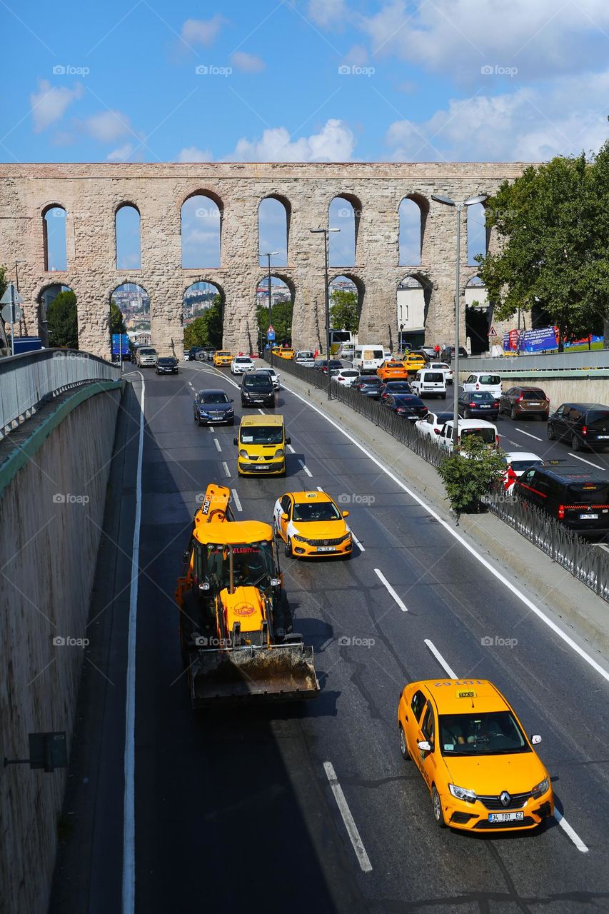 beautiful yellow taxis driving along the road