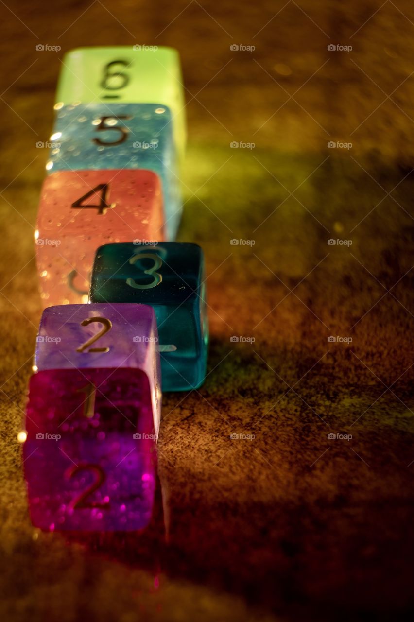 A row of translucent dice in alignment except for a single one out of place. 