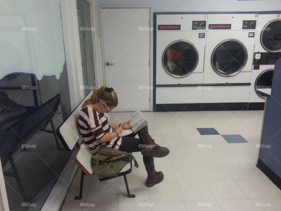 doing homework at the laundromat. doing homework at the laundromat