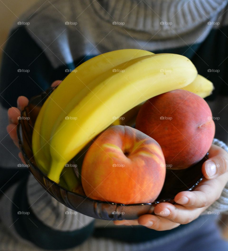 tropics fruits in hands healthy food on a plate background