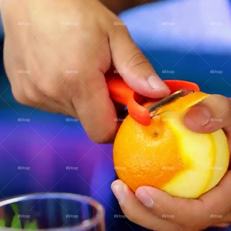 hand peeling orange