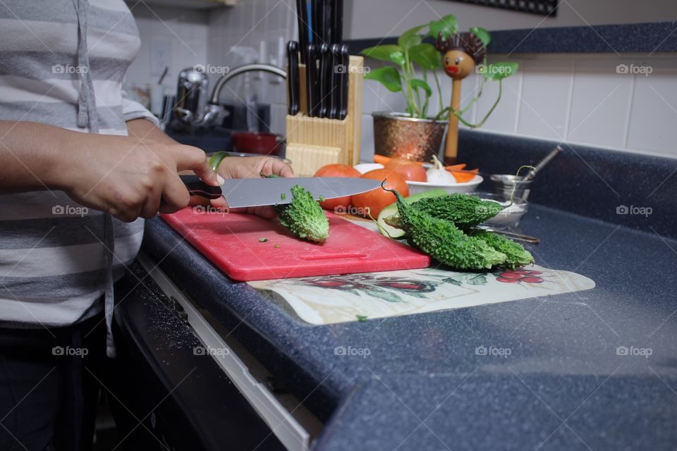 young woman working in her kitchen preparing lunch 