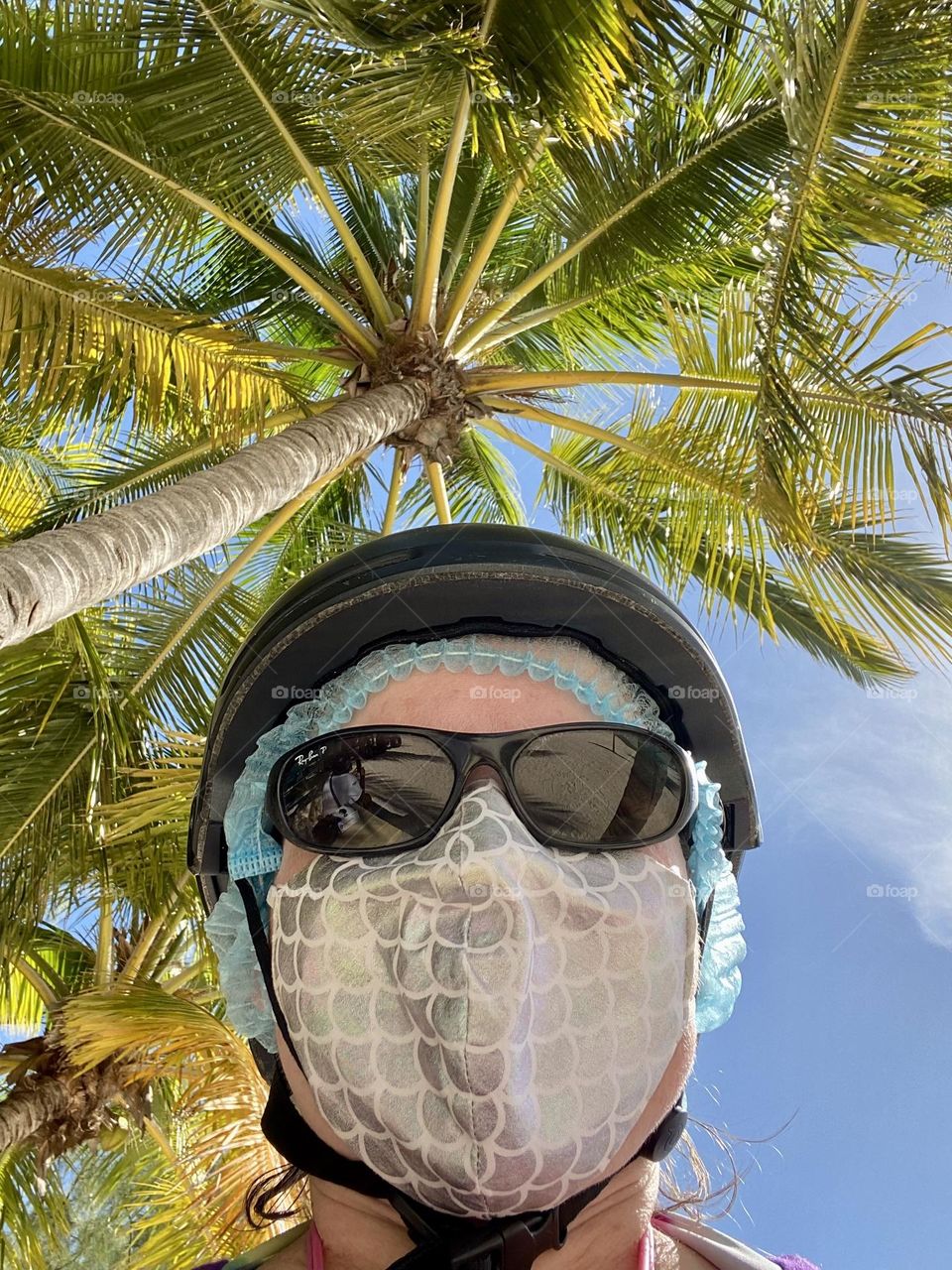 Wearing a hair net, helmet, and face mask before going on a Segway tour in the Bahamas