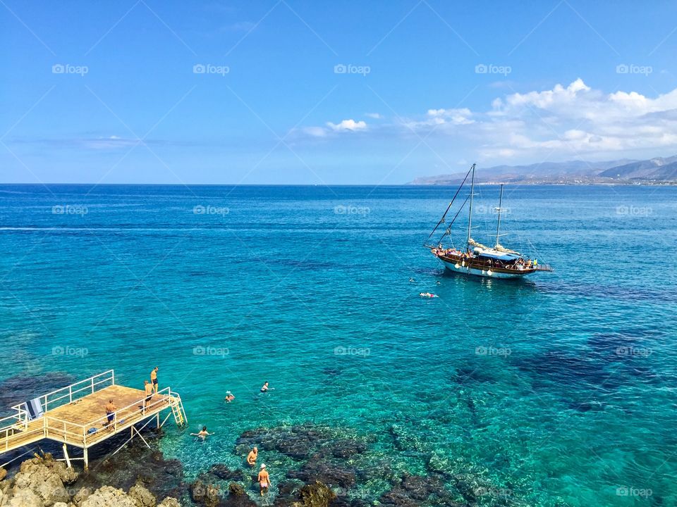 Ship on the sea in Greece near a pontoon