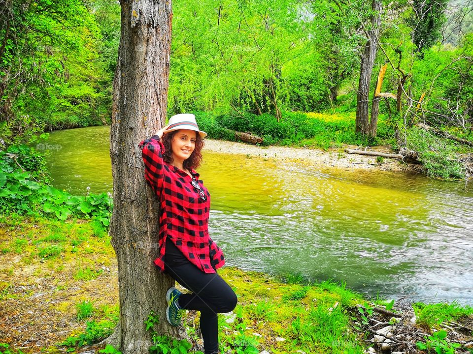 woman with red shirt by the river