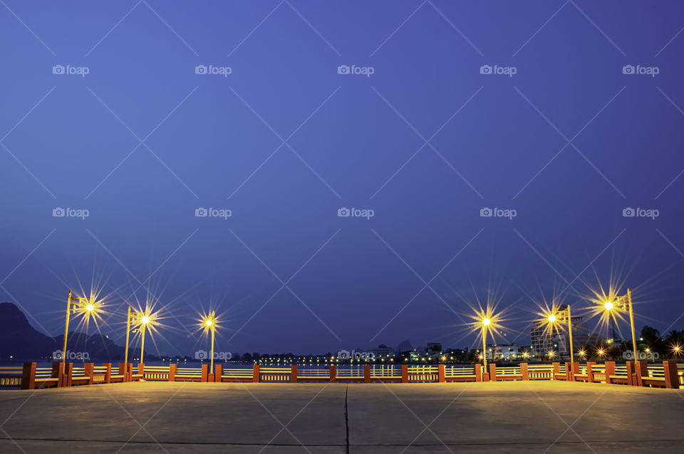 The lights on the bridge at night Background Sea and island at Prachuap Bay in Thailand.