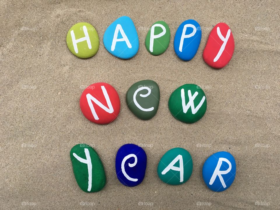 Happy New Year on multicolored stones 