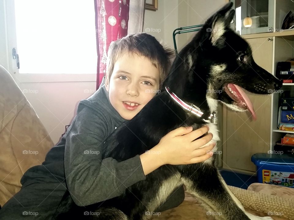 Boy sitting with his dog