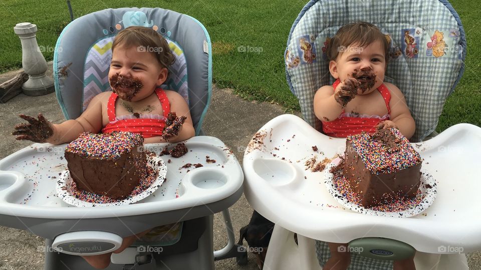 Laughing twin: What is this deliciously messy stuff? 
Serious twin: I believe it's called cake. Yes, cake.