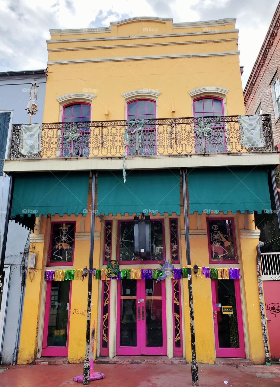 A brightly painted building is decked out for Mardi Gras in New Orleans
