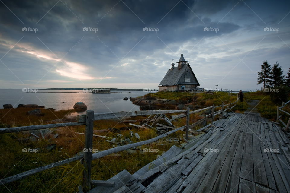 White Sea at early motning. Wooden church in Rabocheostrovsk, Kem, Russia