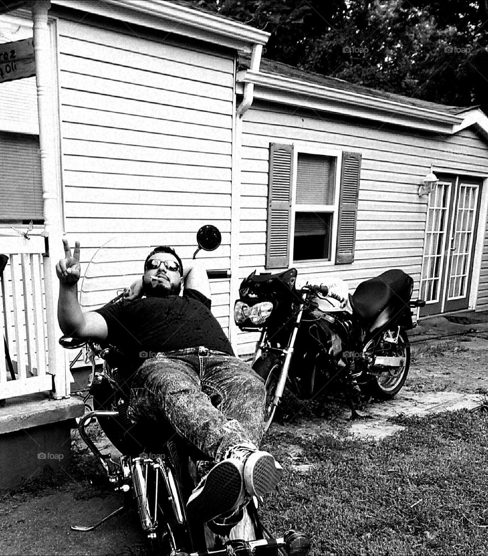 man laying on a motorcycle