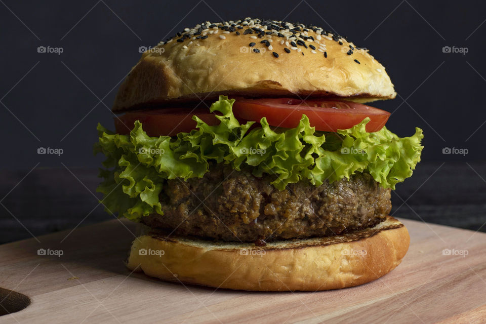 Big hamburger temptation with lettuce and tomato.