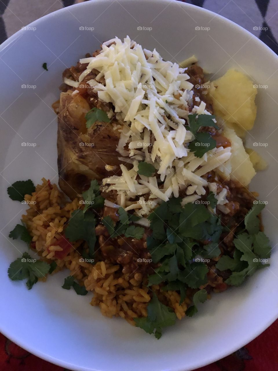 Chilli rice and baked potato with a topping of welsh cheese 