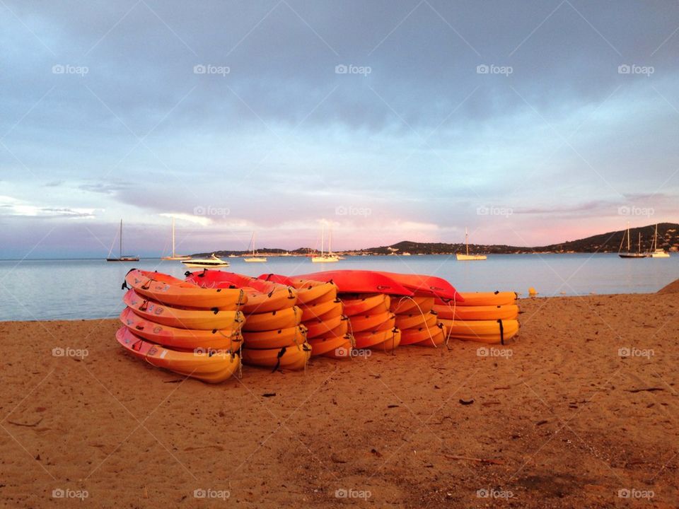 Canoes on the beach at sunset