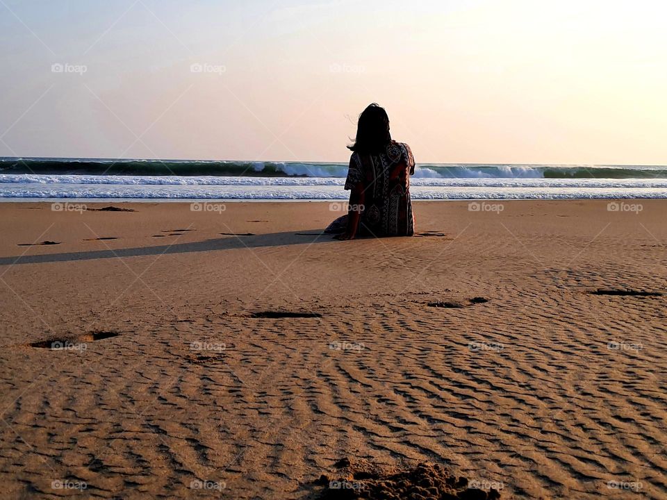 Solitude, enjoying the sunset view of sea