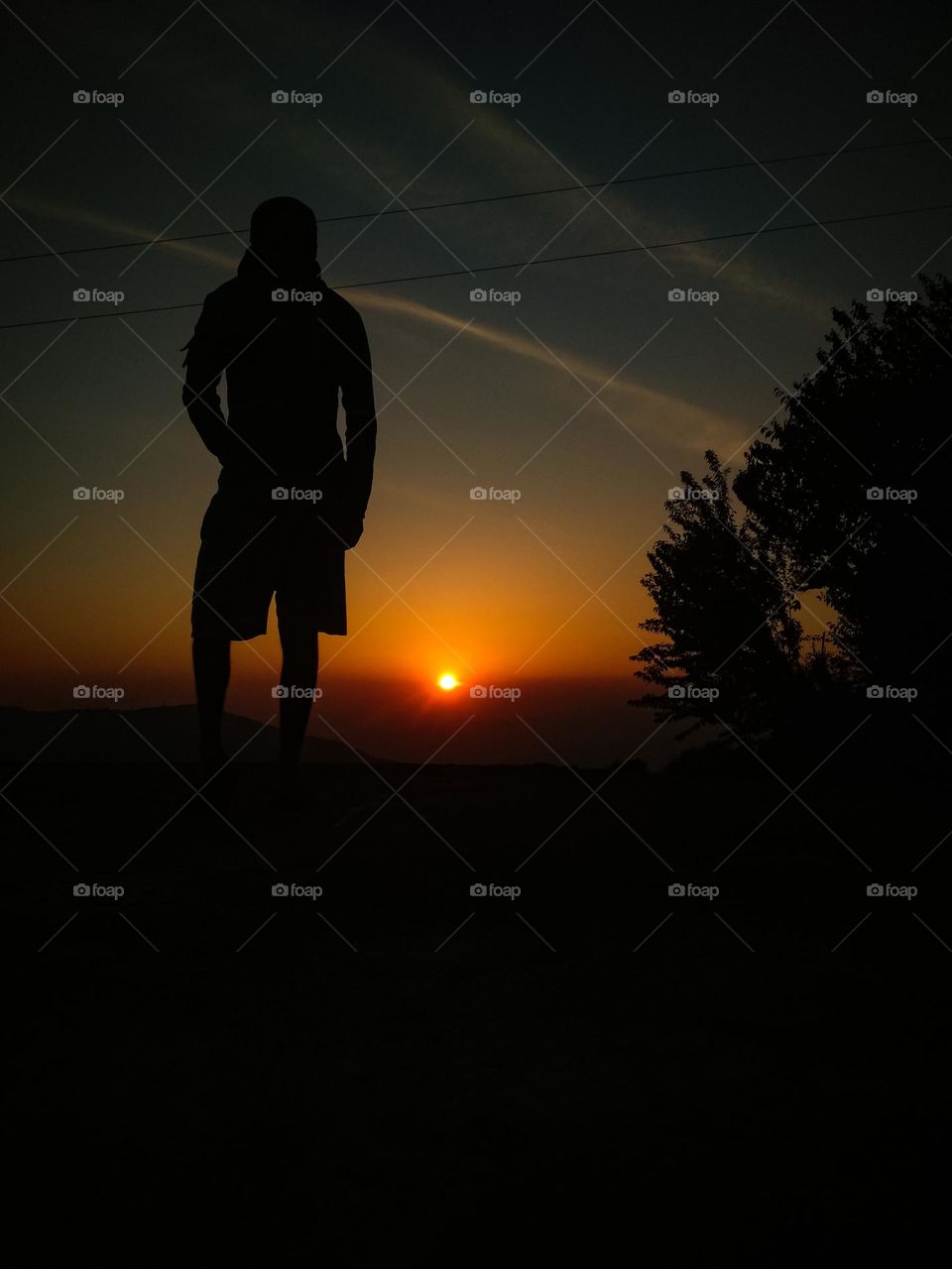 a man standing during sunset view.