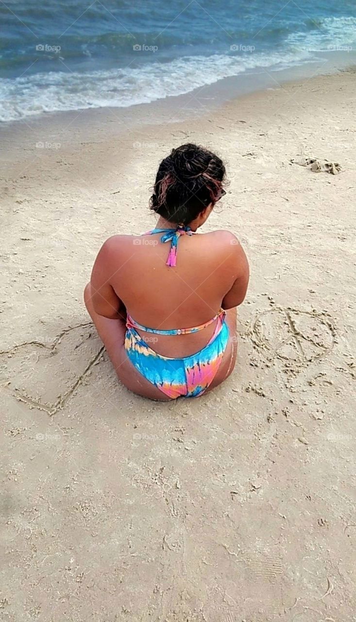 Woman meditating on the beach