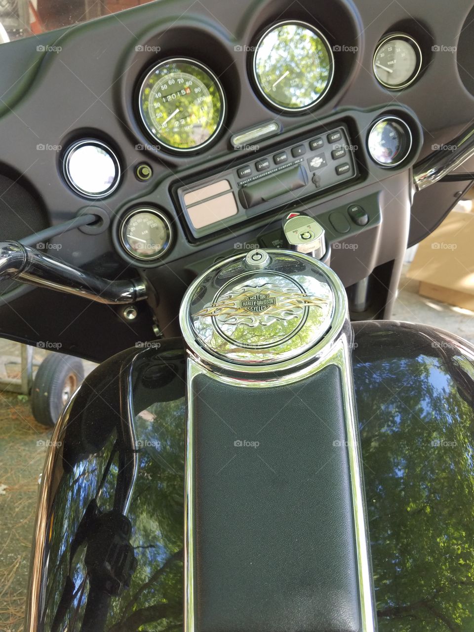 Harley Davidson gas cap with logo in chrome,  dashboard,  windshield.