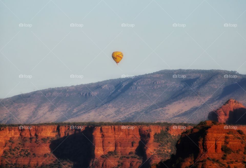 a hot air balloon top of the mountain