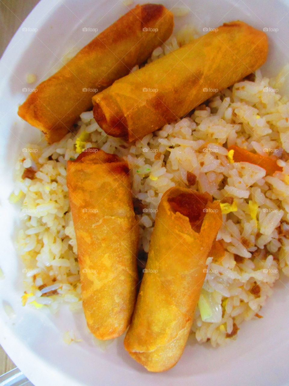 Filipino asian cuisine fried rice with lumpia shanghai roll