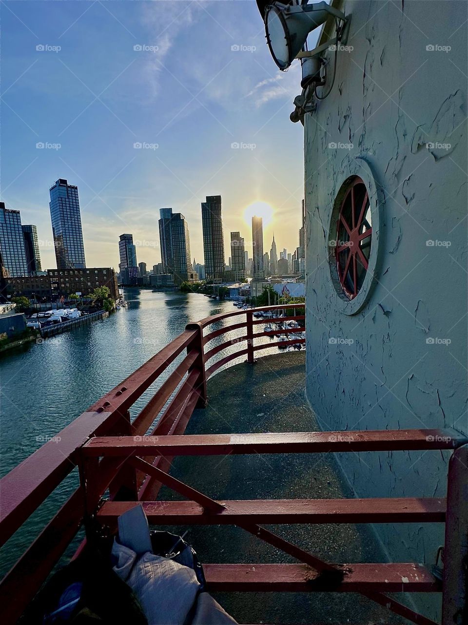This is “Newtown Creek” seen from the “Pulaski Bridge” that connects “Greenpoint”, Bklyn to LIC, Queens. In the distance across the “East River” we see “Manhattan” including the “Empire State Building”. 2024. Hypnotic Productions