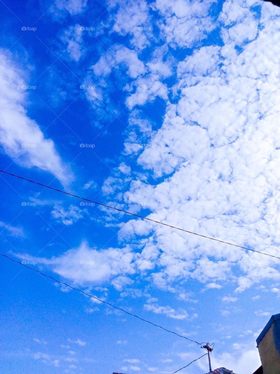 Thick clouds dotted the blue sky