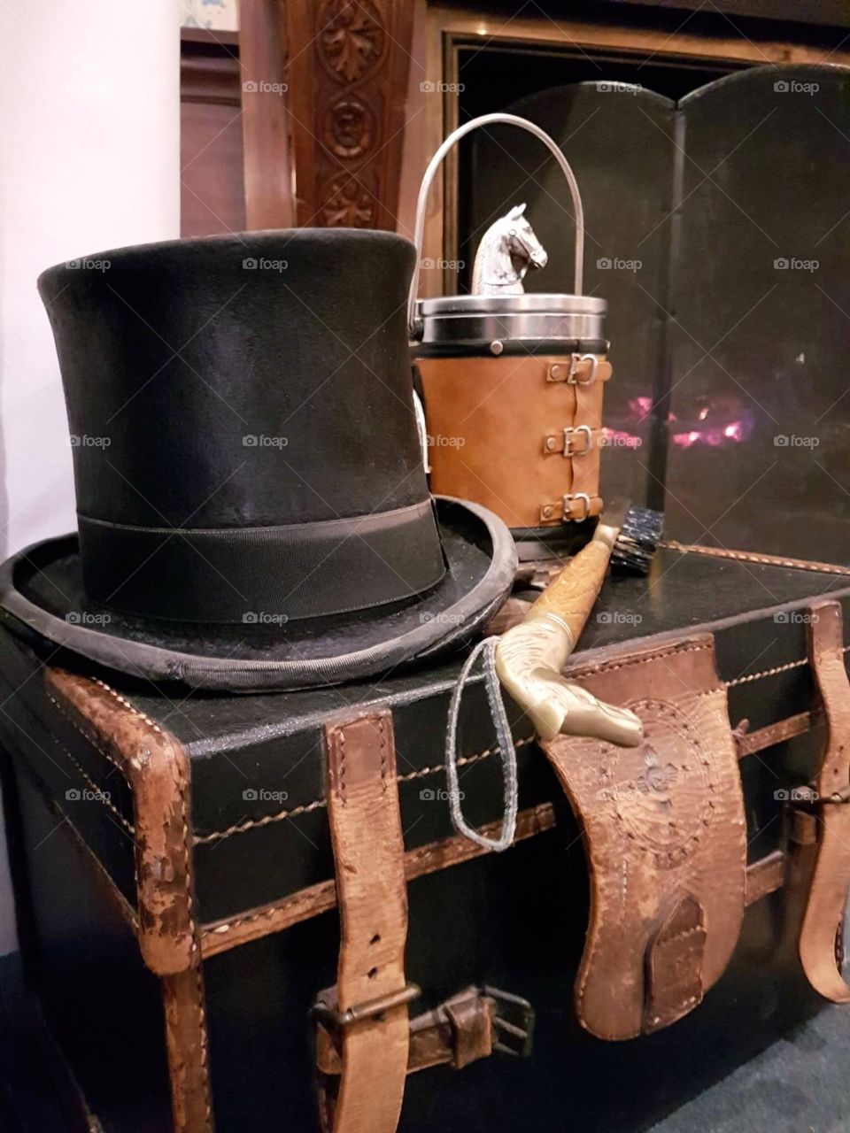 antique top hat, horse head boot brush, trunk, and equine ice bucket