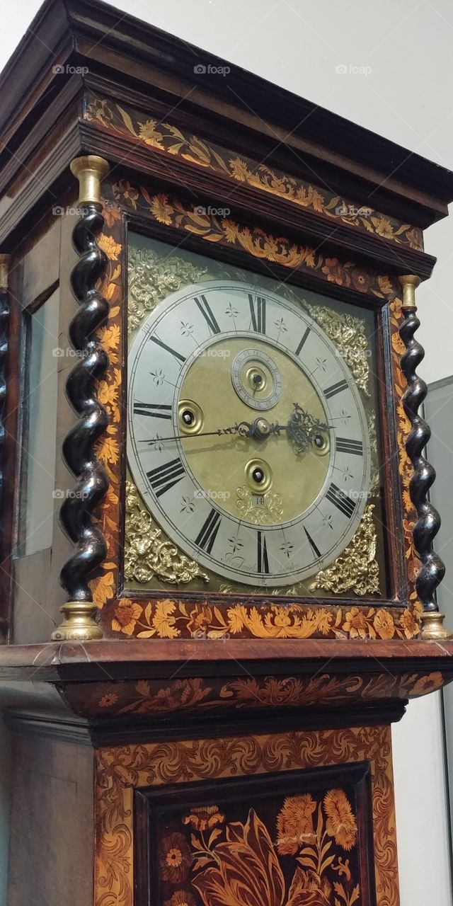 view of face of ornate grandfather clock