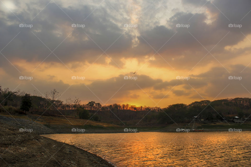 sunset above the reservoir surrounded by hills