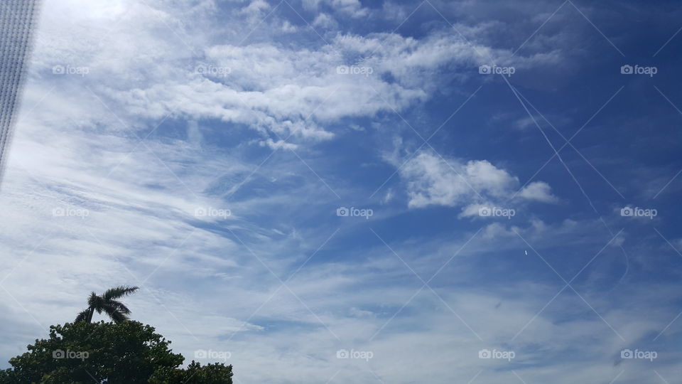 The clouds stretch across the sky on a hot summer day.