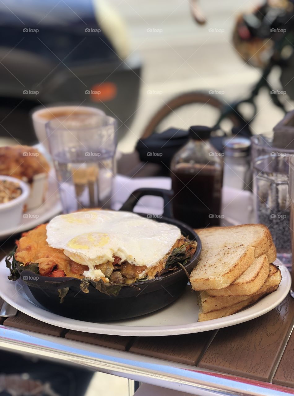 Sunday brunch with my roommate. Had a delicious cast iron skillet full of veggies with two eggs on top and a side of toast. 