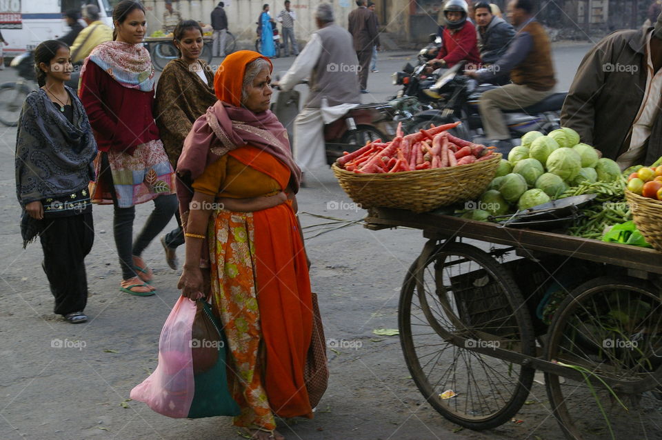 Woman walking near street vendor