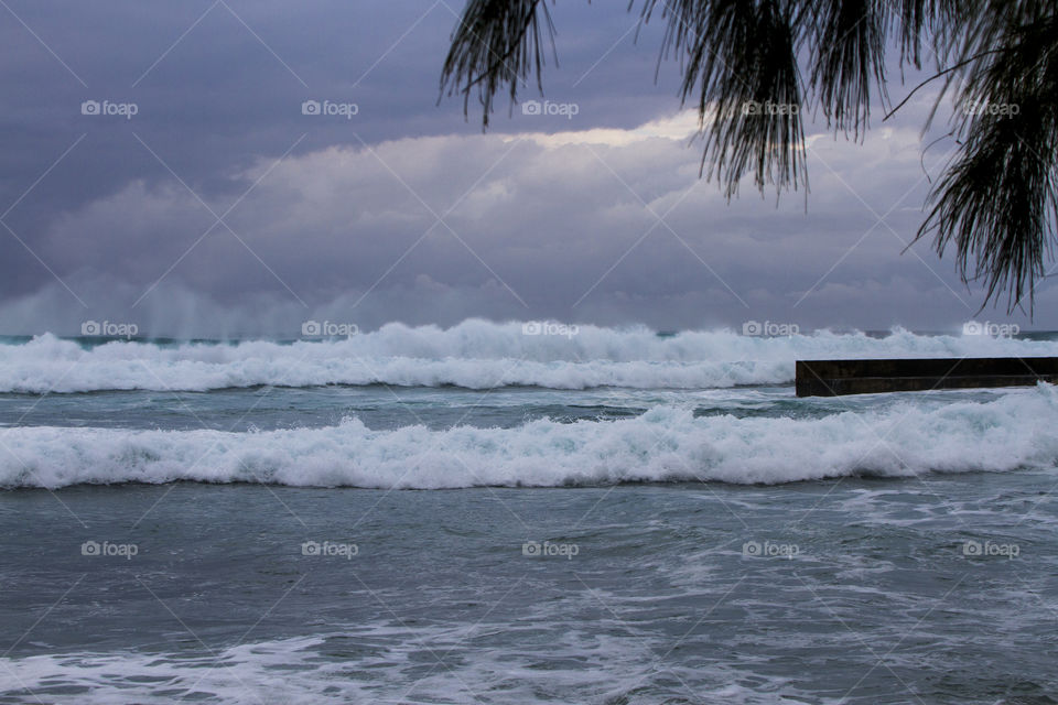 Scenic view of beach against storm cloud