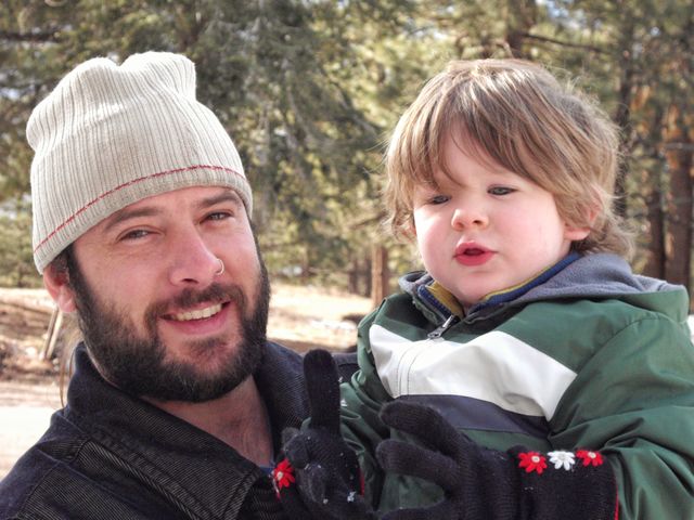 Portrait of father carrying his son