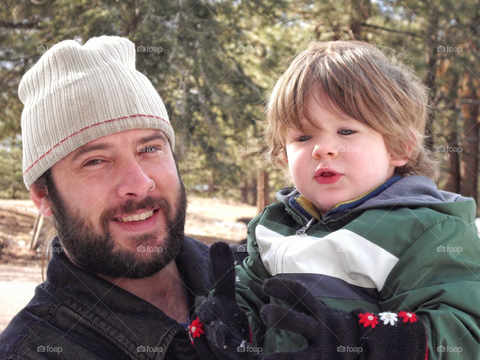 Portrait of father carrying his son