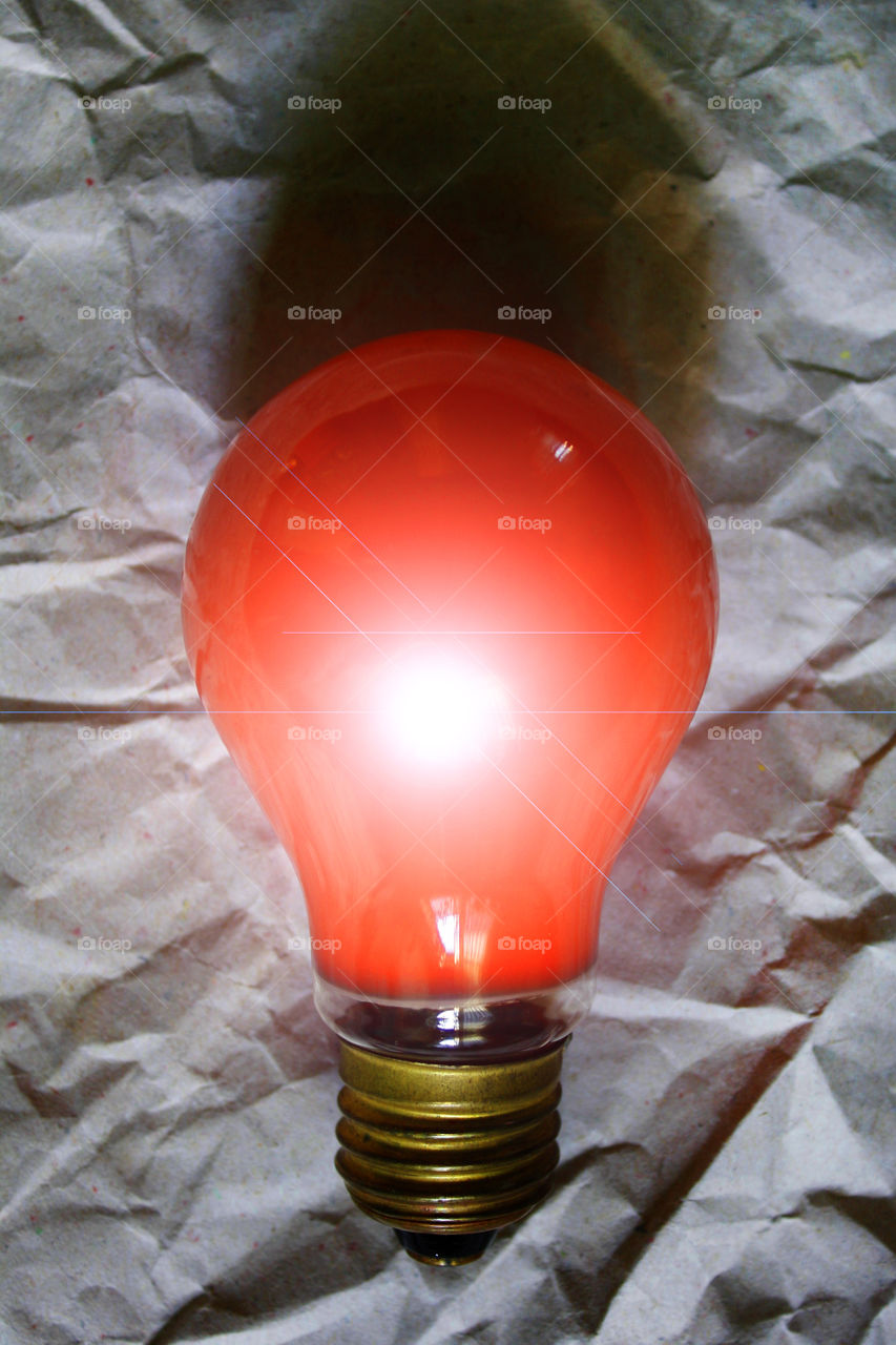 An orange bulb on a paper background 1