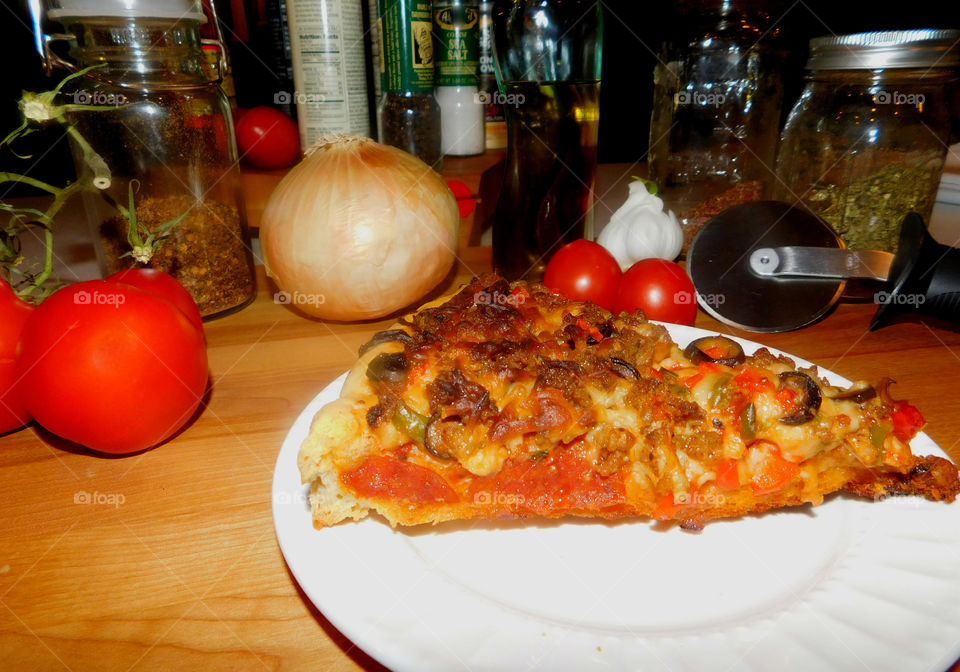 Delicious and nutritious homemade pizza with fresh, colorful vegetables, meats and a variety of spices! Grab a slice!