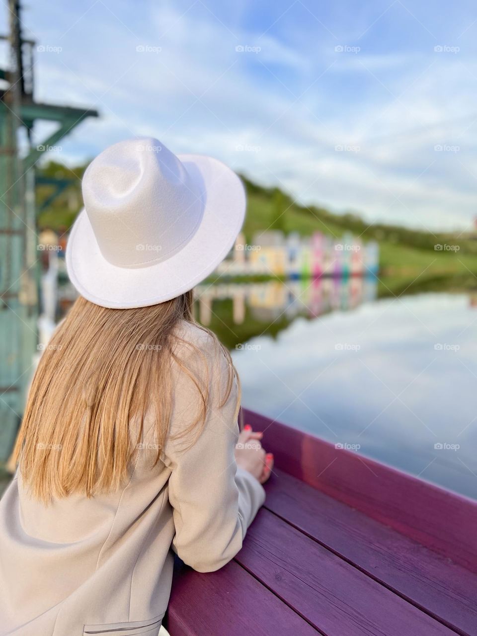 woman in a hat stands and looks into the distance