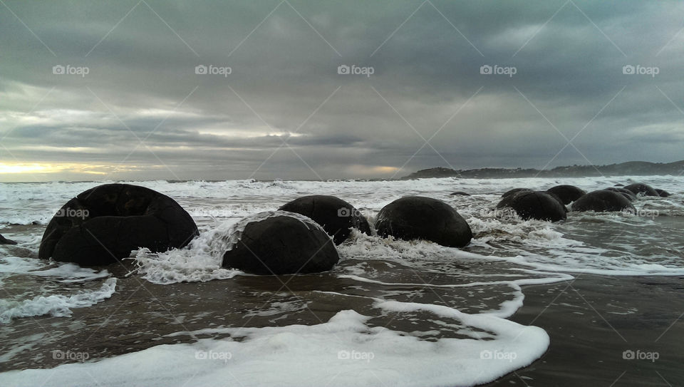 Surf crashing on boulders
