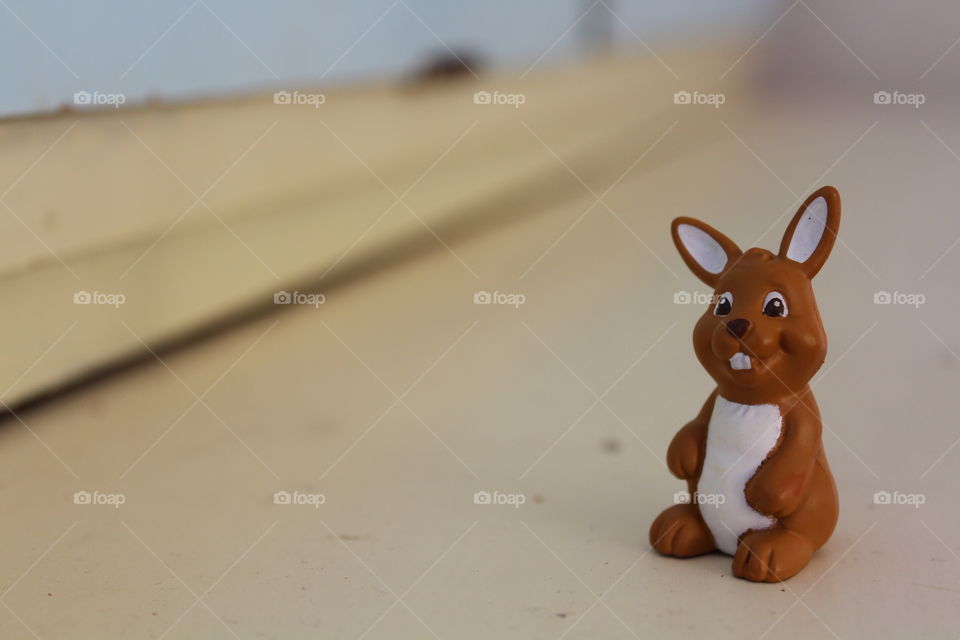 macro close-up of a brown bunny toy sitting on the edge