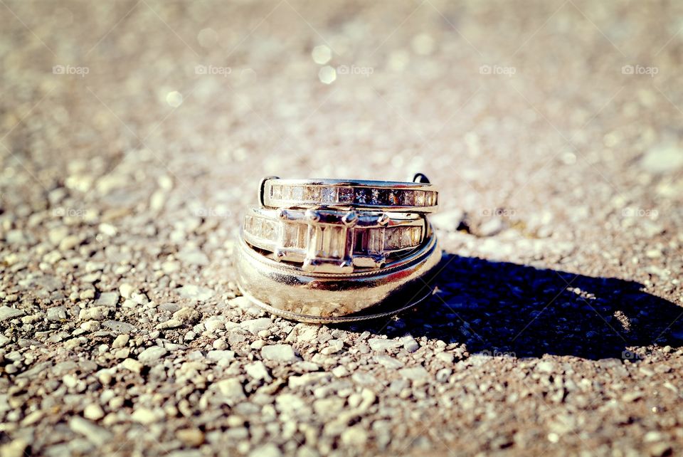 His and her wedding rings stand as one.