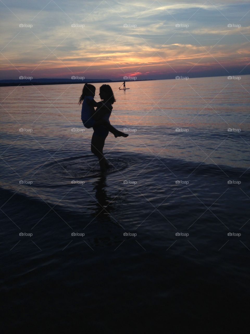 Silhouettes at sunset in Wasaga Beach Ontario. 