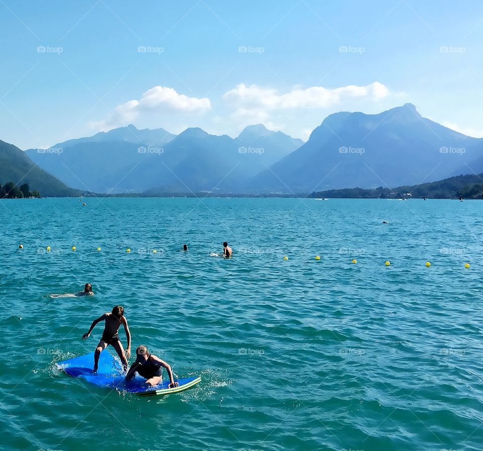 Children swimming in a lake