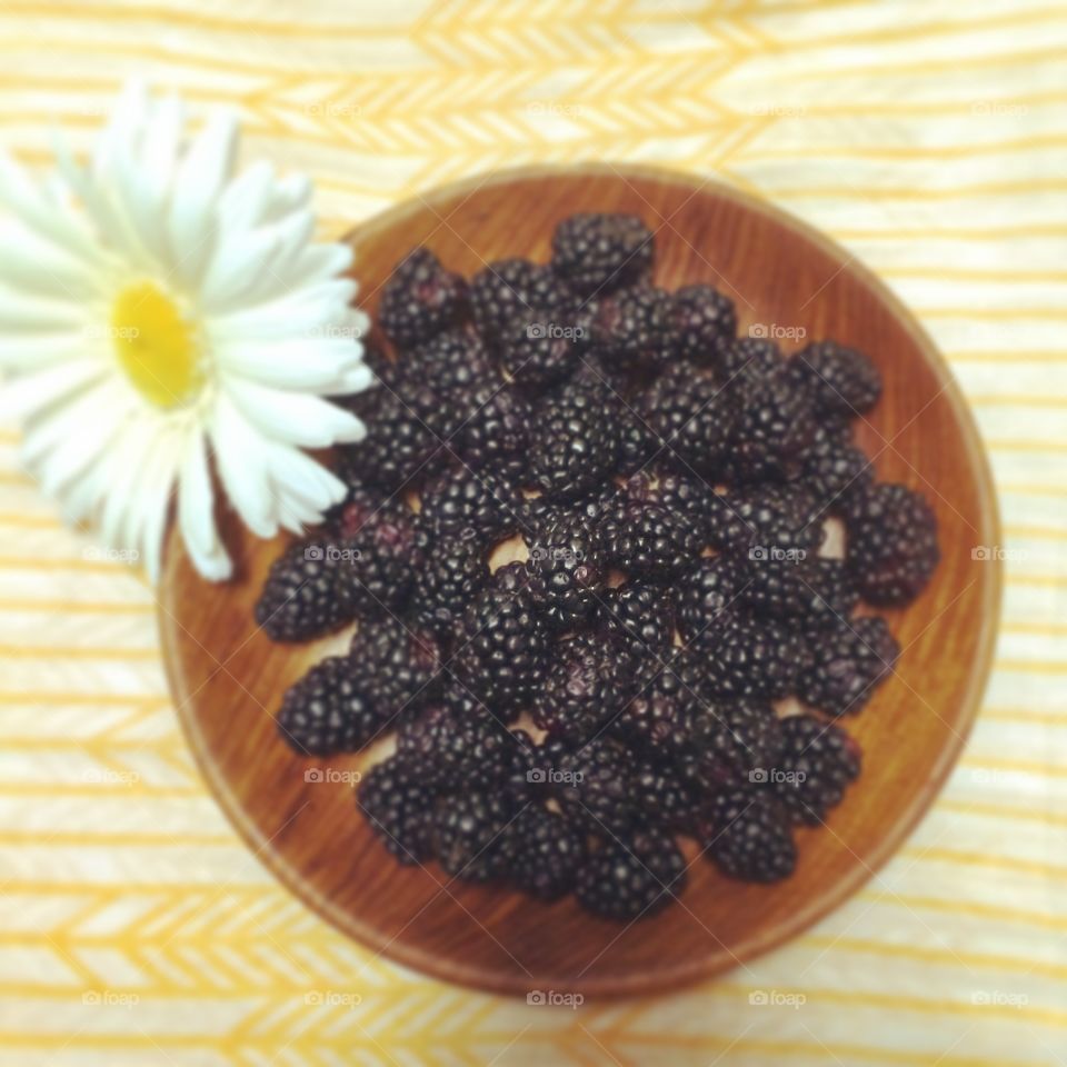 Wooden bowl of blackberries
