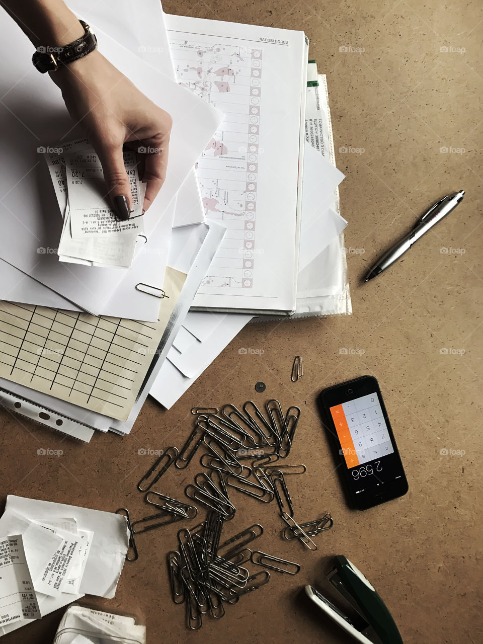 Woman getting an order in finances, managing papers, and planning a budget 