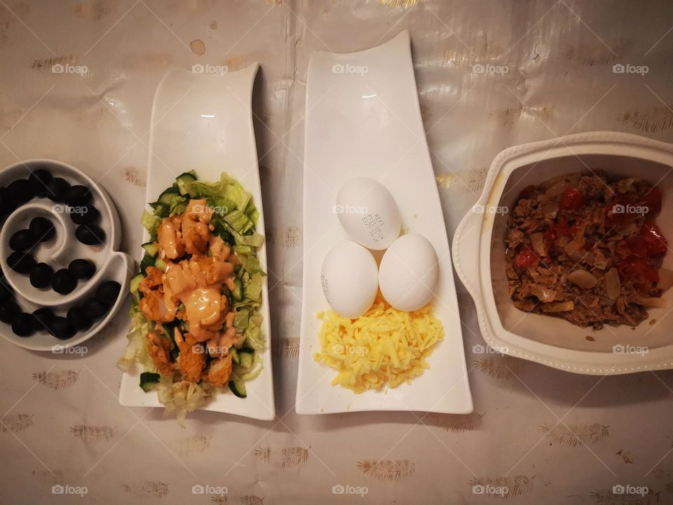 Caesar salad with olives, boiled eggs and tuna meat