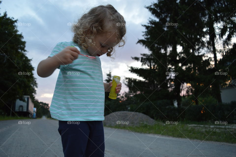 Girl trying to makes bubbles