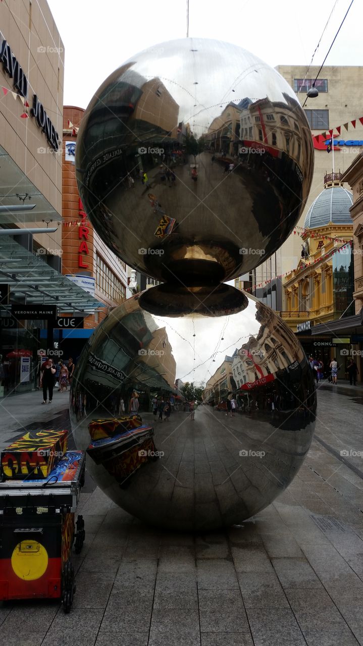Reflection in two balanced metal balls in Rundle Mall Adelaide Australia.